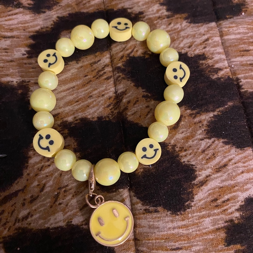Handcrafted yellow beaded bracelet with smiley face and smiley face charm